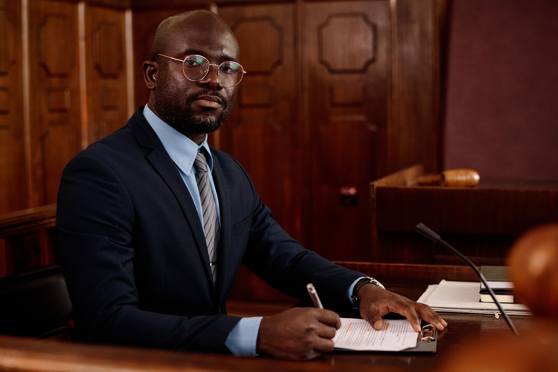 Young successful African American male attorney in eyeglasses and formalwear