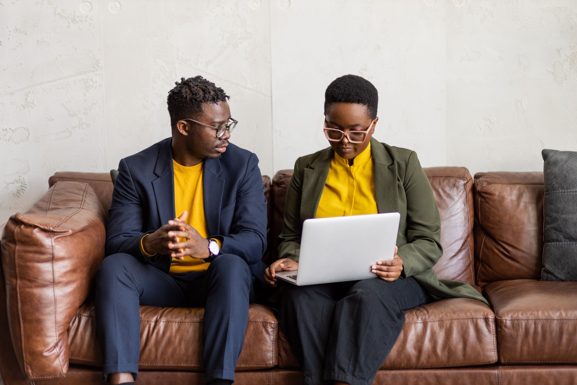 Young African-American colleagues on laptop