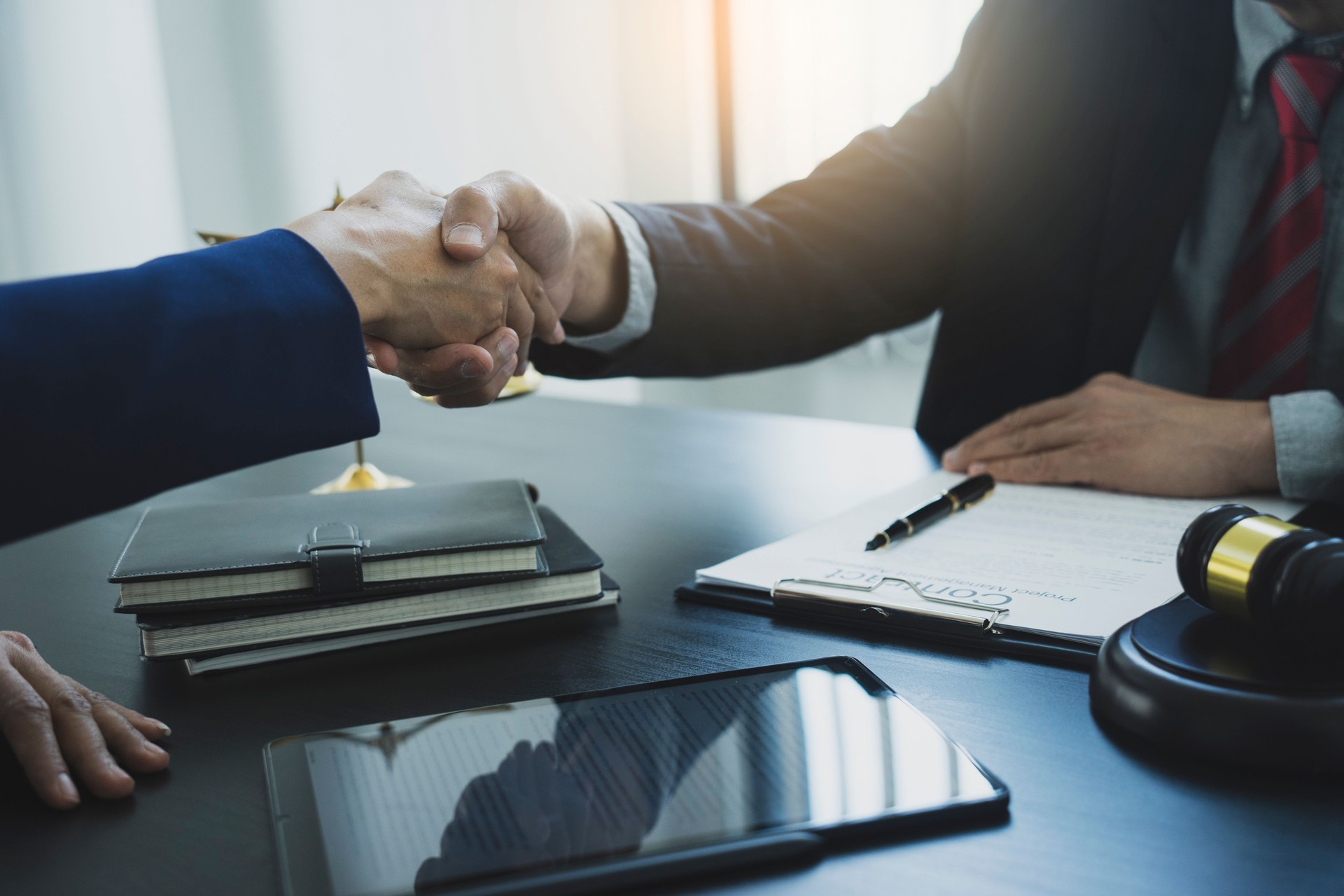 Two businessmen are shaking hands to congratulate a contract