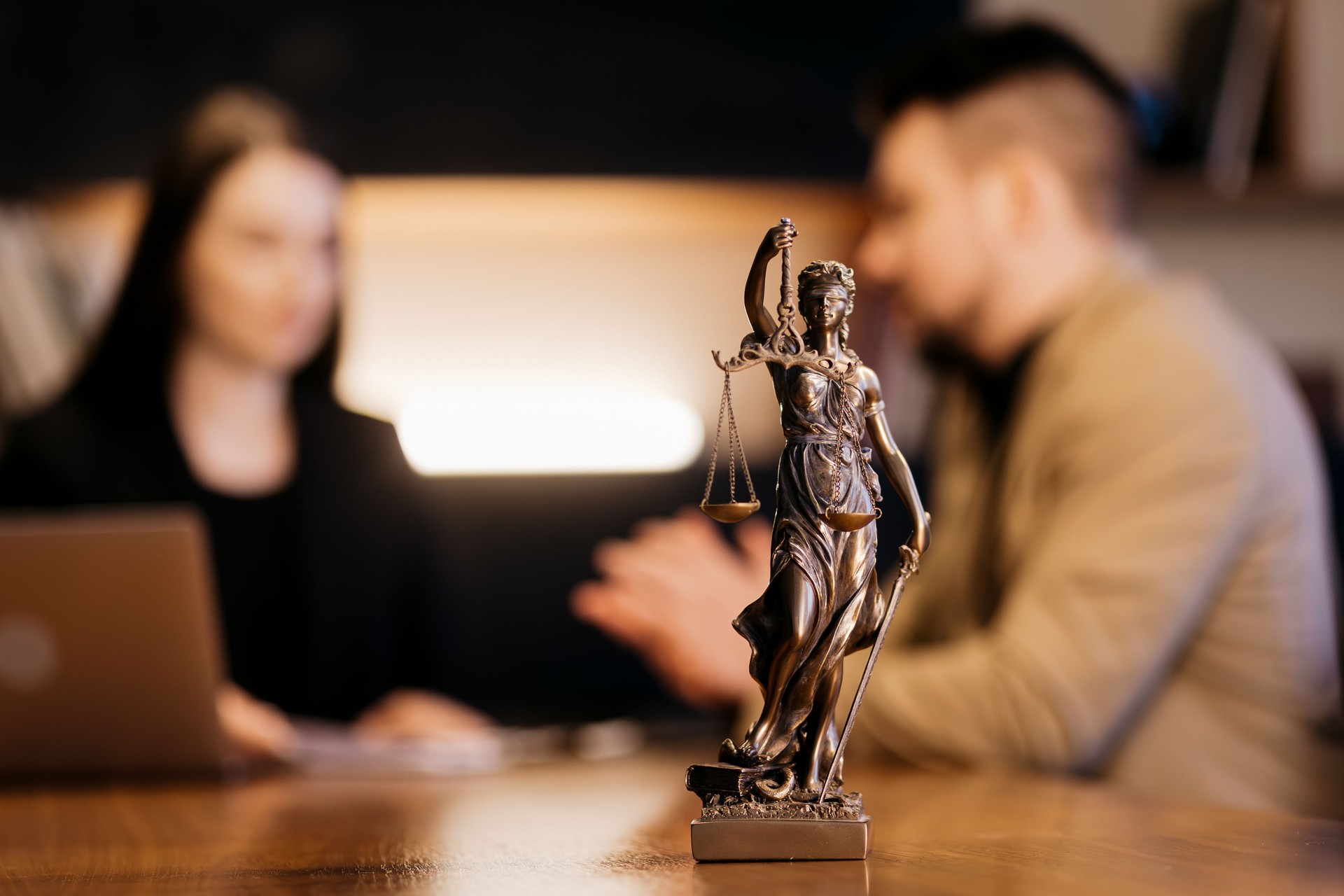A lawyer advises a client on tax and legal issues in the office of a legal services firm.
