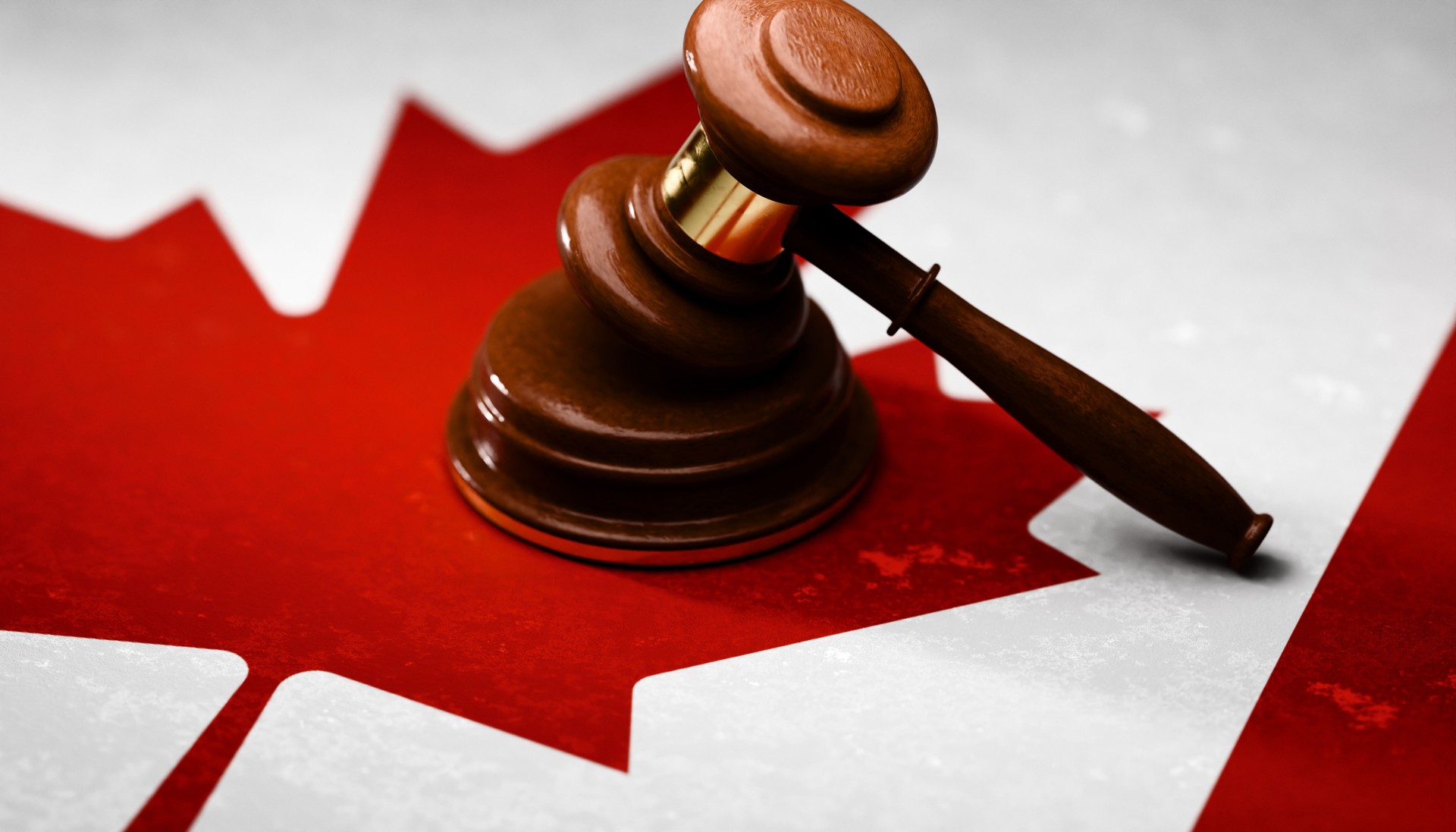 Gavel sitting on top of textured Canadian flag